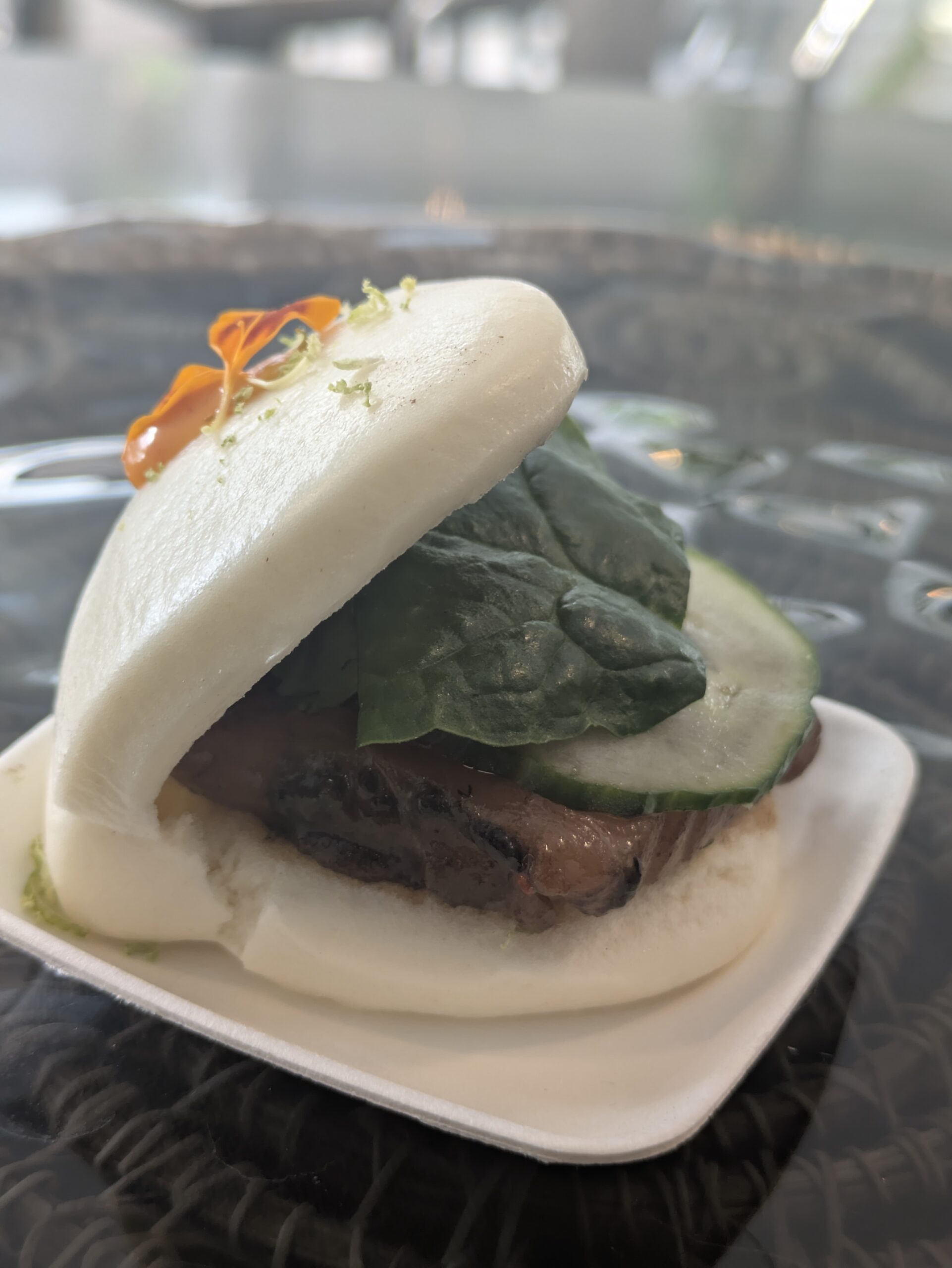 Bao of wild salmon ceviche with black garlic